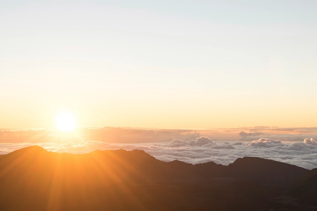 sun rising over mountains